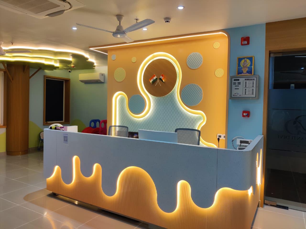 Pediatric reception area with colorful wall lighting at Damyanti Devi Hospital